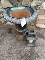 Cast iron urn with lantern adjacent showing scale and condition