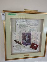 Full view of framed collage with picture light attached