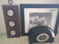 Group showing framed print, mantel clock, and weather station plaque
