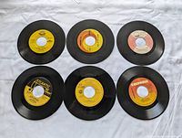 Six 7-inch singles laid out label-side up