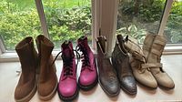 All four pairs of boots lined up on window ledge, showing overall styles and colors