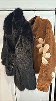 Both jackets on rack showing colors and styles