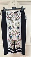 Front view of Ted Baker skirt showing print, black side panels, front slit
