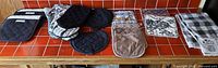 All twelve kitchen linen pieces laid out on counter
