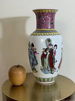Full view of vase next to apple for scale