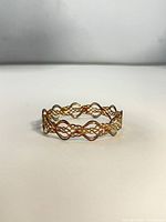 Angled view of full bangle showing braided design
