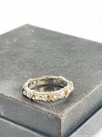 Oblique view of ring showing cubic zirconia settings and wear