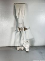 two white dashboard-style steering control shell components standing vertically