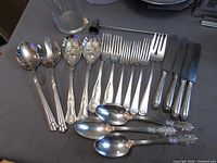 All utensils, candle snuffer and vase laid out