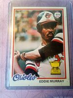 Front view of Eddie Murray Topps card showing player image, team name, Rookie Cup and wear