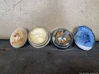 Group shot of onyx egg, two crystal glass domes and blue geode half