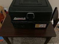 Closed Fenwick tackle box on table