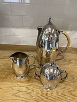 Front view of coffee/teapot, creamer, sugar bowl
