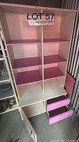 Full front view of shelving unit showing shelves, drawers and cabinet door