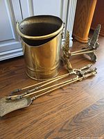 overall view showing coal scuttle, pair of andirons and three tools