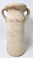 Front view of unglazed clay vase with handles