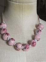 Full view of necklace on mannequin showing bead count and cord