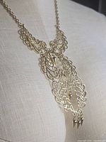 Full view of necklace on display form showing chain and complete pendant design