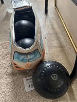 Three black lawn bowls inside VW van style case