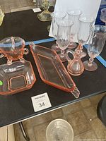 Overall view of all pink depression glass items on table