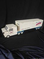 Full view of cardboard tractor and trailer attached