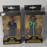 Front view of both boxed Funko Gold figures