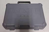 Closed grey carry case with Dremel 3000 logo