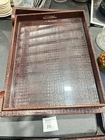 Top view of brown faux crocodile tray showing pattern and clear insert