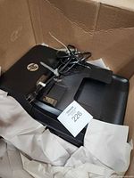 Top view of HP all-in-one printer in packing with power cord
