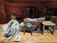 Shelf view of rabbit, cat, metal animal sculpture, fruit planter and tulip planter