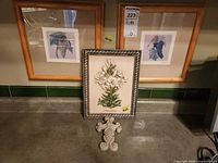 Group shot showing two framed prints, framed relief plaque, and wall ornament