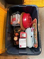Contents of tote showing ornaments, tray, domed bowl, candle and décor pieces