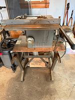 Front view of Craftsman table saw on stand showing motor and rip fence