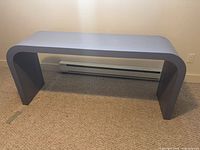 Front view of gray waterfall console table
