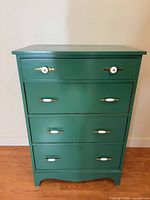 Front view of green four-drawer dresser