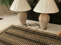 Two matching ceramic table lamps with shades showing full view and cords