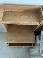 Top view showing grain pattern, open cubby, and drawer interior
