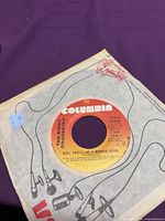 Side A label showing title Girl You'll Be A Woman Soon and Columbia branding