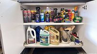Overall view of cabinet with detailing products, jugs, towels and charger