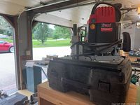Freud plunge router on case, garage background