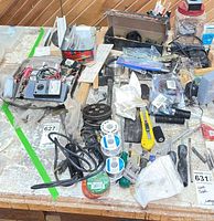 Overall lot with assorted hand tools, solder spools, knives, pliers, hardware on workbench