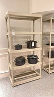 Front view of beige 4-shelf plastic unit with contents shown for scale