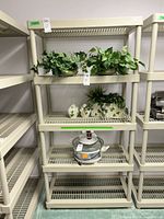 Front view of beige plastic 5-shelf unit with ventilated shelves