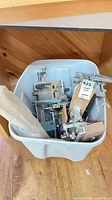 Overview of bin holding assorted clamps, wood blocks and hardware