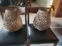 Two wicker rattan lantern baskets on chairs