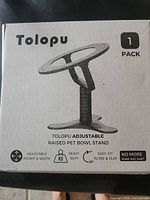 Retail box displaying Tolopu adjustable pet bowl stand diagram and features