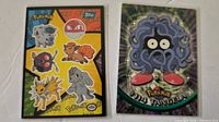 Front view of both Topps Pokémon cards in sleeves showing sticker sheet and Tangela card