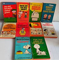 Front covers of ten Peanuts paperbacks arranged in two rows