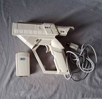 Gun controller and receiver laid on grey cloth showing overall condition