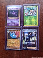 Group shot of all four sleeved Pokémon cards